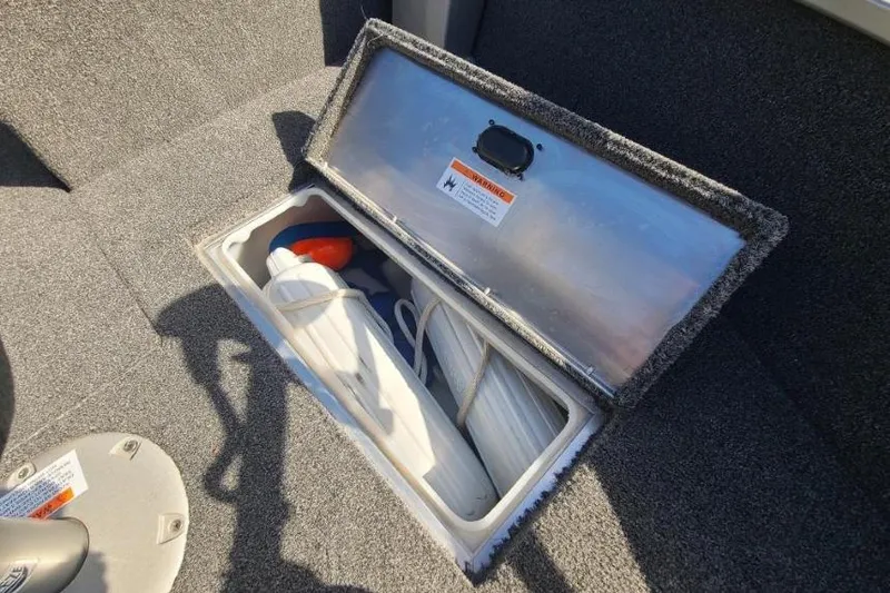 Slide: The Image of 2016 Lowe Fishing Machine 165SC Pro storage compartment with safety equipment inside. - 16