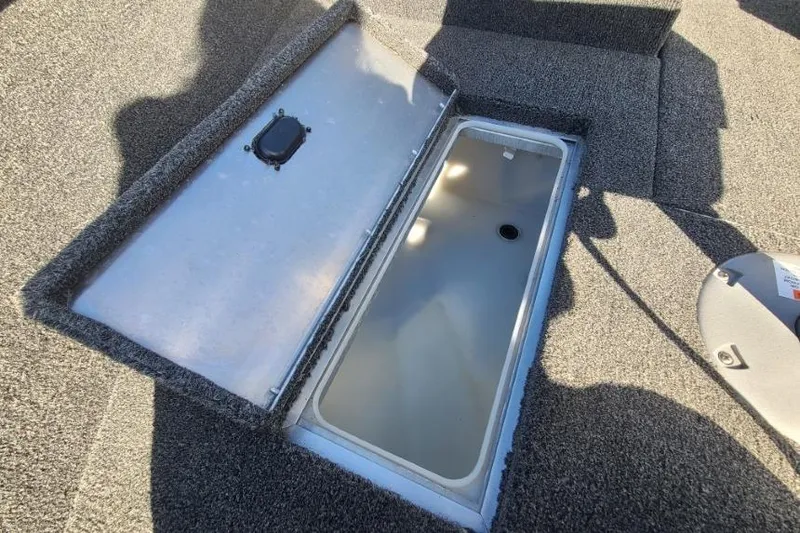 Slide: The Image of Open storage compartment on 2016 Lowe Fishing Machine 165SC Pro boat. - 17