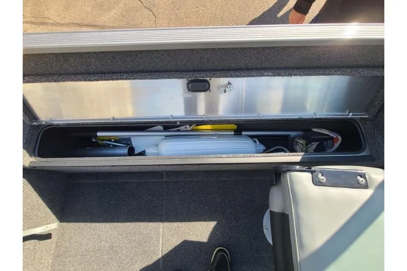 Slide: The Image of Storage compartment of 2016 Lowe Fishing Machine 165SC Pro boat, containing various equipment. - 18