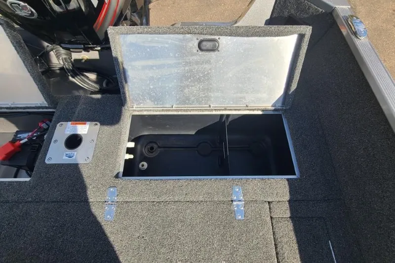 Slide: The Image of 2016 Lowe Fishing Machine 165SC Pro boat storage compartment open, showing interior details. - 19