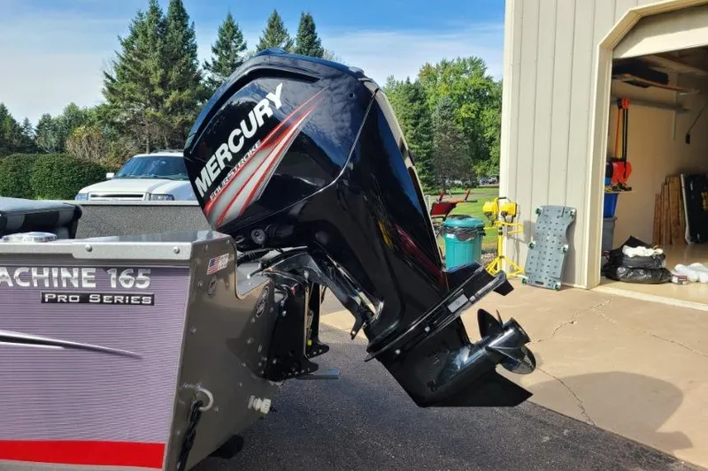 Slide: The Image of 2016 Lowe Fishing Machine 165SC Pro with Mercury outboard motor in driveway. - 3