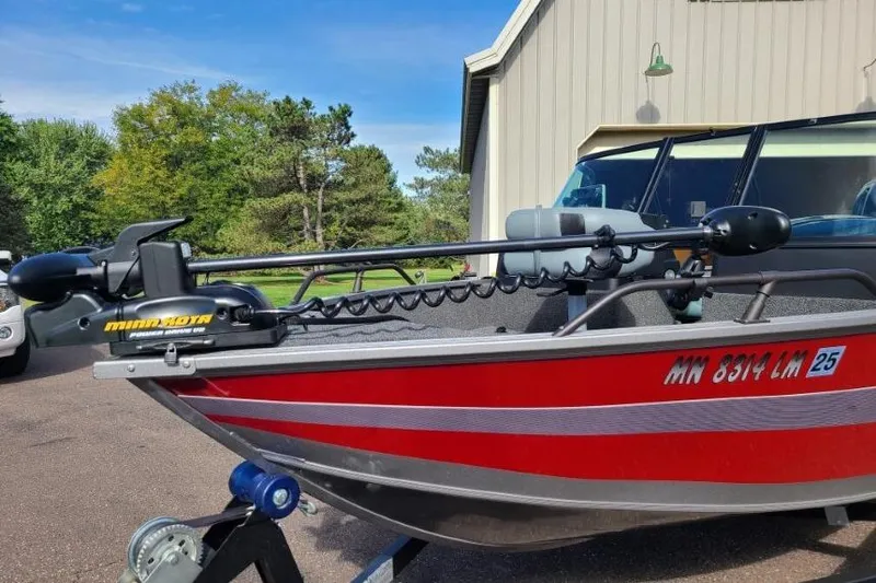 Slide: The Image of 2016 Lowe Fishing Machine 165SC Pro with Minn Kota trolling motor, parked outdoors. - 5