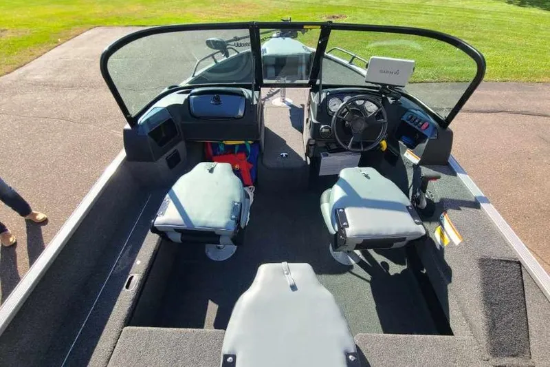 Slide: The Image of 2016 Lowe Fishing Machine 165SC Pro interior with seating and steering console. - 6