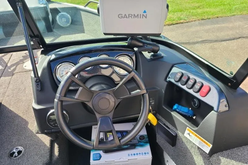 Slide: The Image of 2016 Lowe Fishing Machine 165SC Pro dashboard with Garmin GPS and control panel. - 9