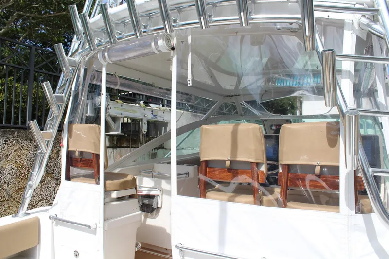 Slide: The Image of 2008 Contender 38 Express boat interior with beige seats and rod holders. - 10