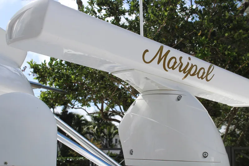 Slide: The Image of 2008 Contender 38 Express boat with "Maripal" name, surrounded by trees. - 11
