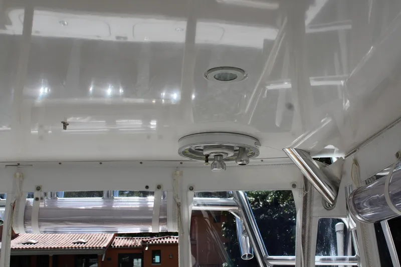 Slide: The Image of 2008 Contender 38 Express boat interior ceiling with lighting and rod holders. - 12