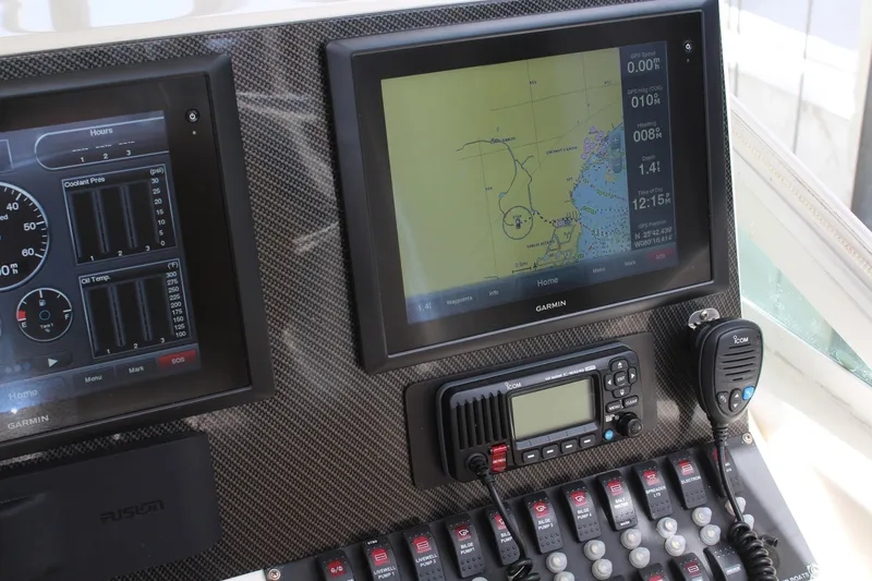 Slide: The Image of Dashboard of a 2008 Contender 38 Express with Garmin navigation and communication equipment. - 16