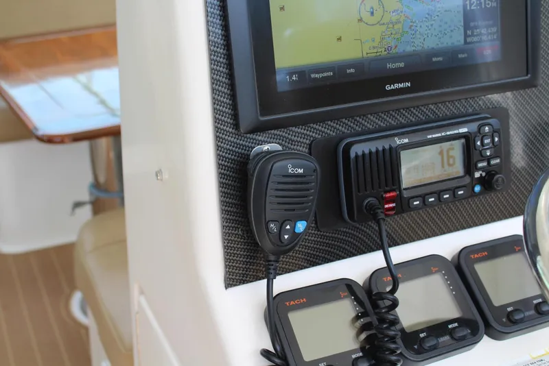 Slide: The Image of 2008 Contender 38 Express dashboard with Garmin GPS and Icom radio equipment. - 17