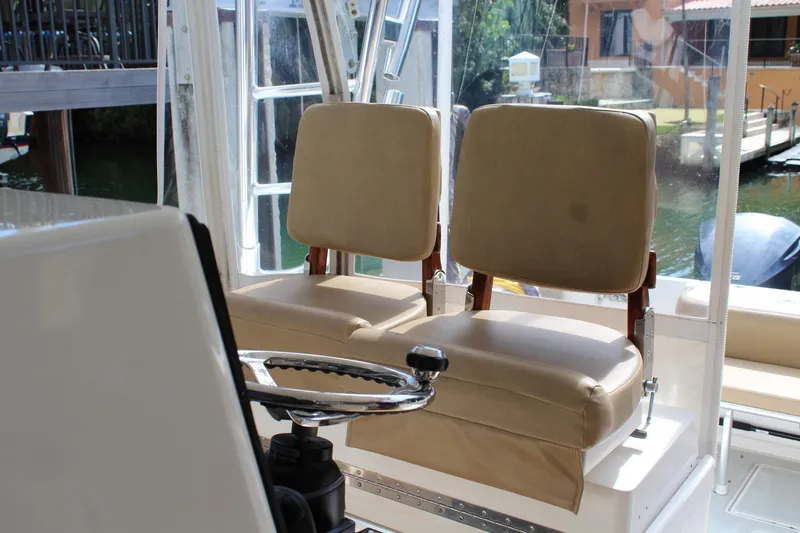Slide: The Image of 2008 Contender 38 Express boat interior with dual beige captain seats and steering wheel. - 19