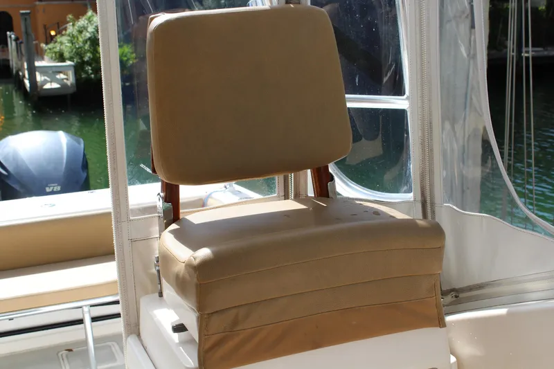 Slide: The Image of Captain's chair on a 2008 Contender 38 Express boat, with beige upholstery. - 21