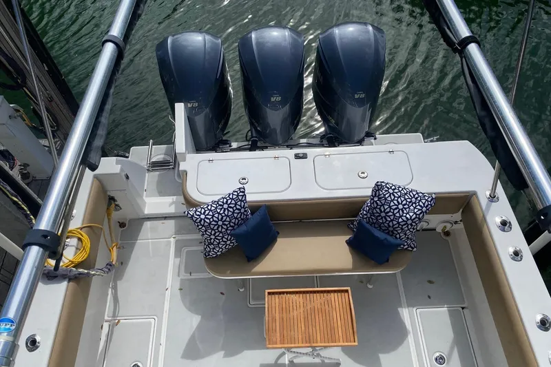 Slide: The Image of 2008 Contender 38 Express boat with triple engines and cushioned seating area. - 23