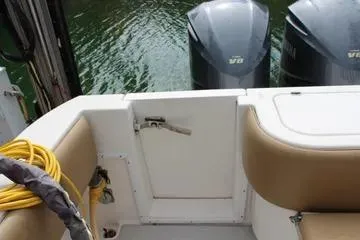 Slide: The Image of 2008 Contender 38 Express boat with twin outboard engines and beige seating. - 27