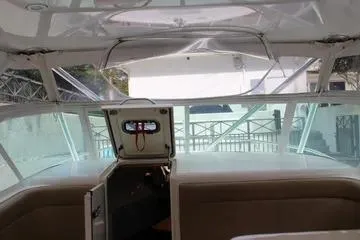 Slide: The Image of 2008 Contender 38 Express boat interior with open hatch and seating area. - 32