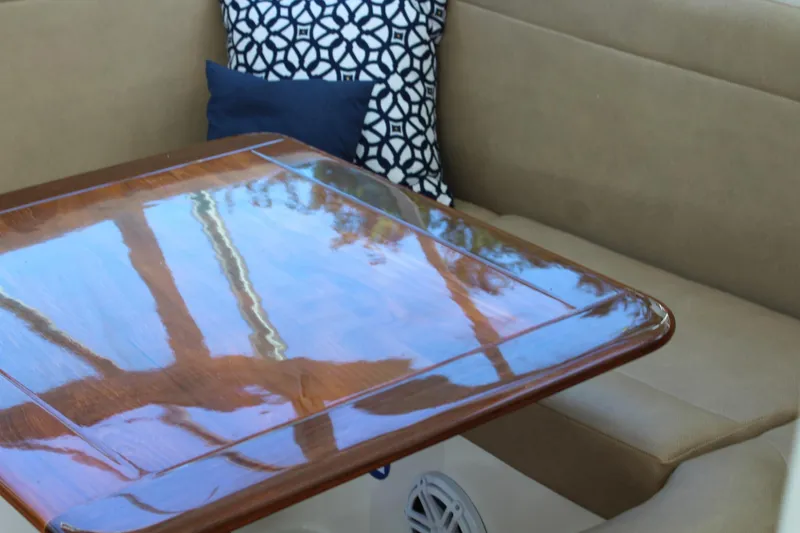 Slide: The Image of Interior of 2008 Contender 38 Express with polished wooden table and cushioned seating. - 34