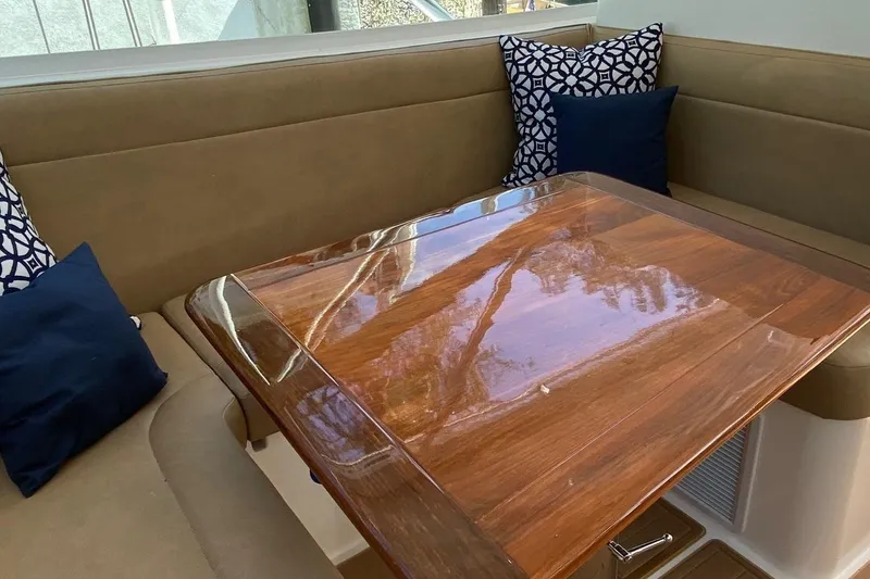 Slide: The Image of Luxurious interior of 2008 Contender 38 Express with polished wood table and cushioned seating. - 36