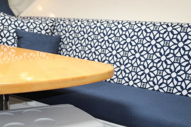 Slide: The Image of Interior of 2008 Contender 38 Express with patterned seating and wooden table. - 38