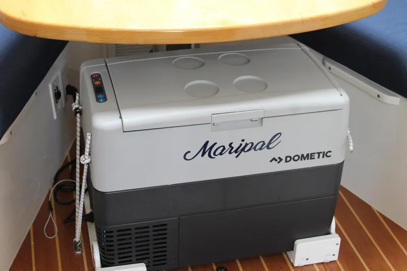 Slide: The Image of Dometic cooler under table on 2008 Contender 38 Express boat interior. - 42