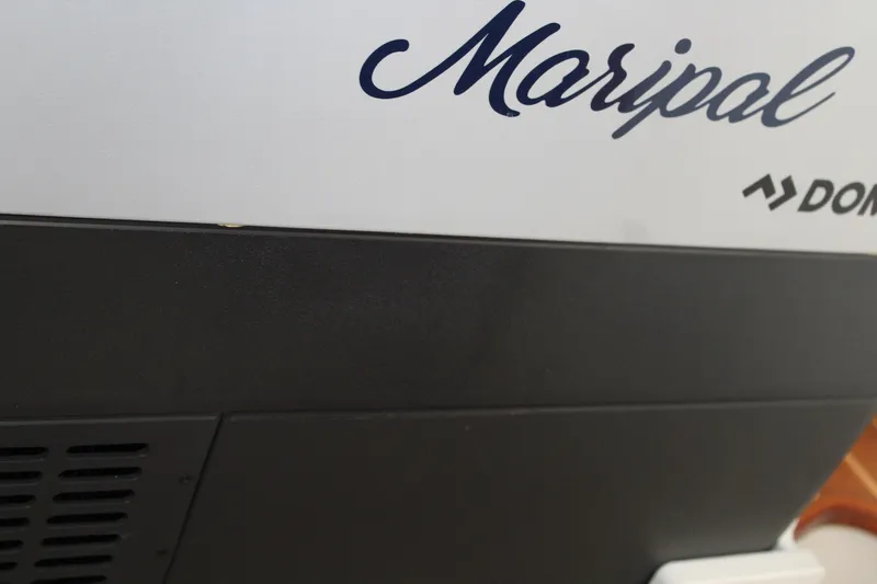 Slide: The Image of Close-up of a Contender 38 Express 2008 boat with "Maripal" and "DOM" text. - 52