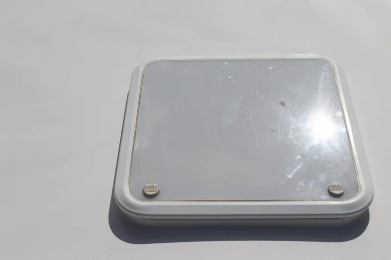 Slide: The Image of Hatch on 2008 Contender 38 Express boat, reflecting sunlight. - 55