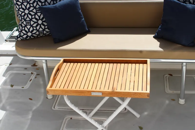 Slide: The Image of Luxury seating area on 2008 Contender 38 Express boat with wooden tray and cushions. - 59