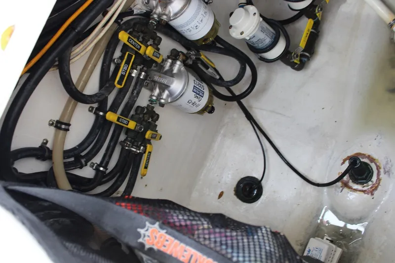 Slide: The Image of Engine compartment of 2008 Contender 38 Express with fuel lines and filters visible. - 61