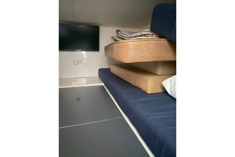 Slide: The Image of Interior cabin of 2008 Contender 38 Express with cushions and wall-mounted TV. - 73