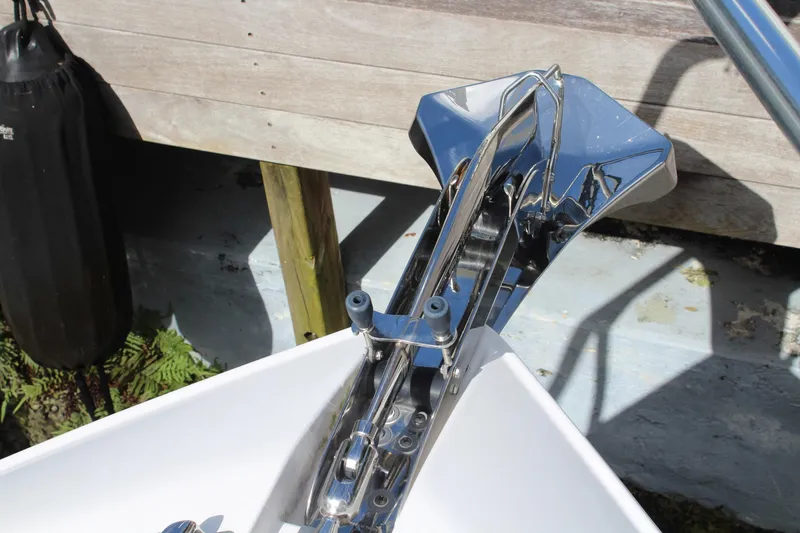 Slide: The Image of Chrome anchor on 2008 Contender 38 Express boat, docked with wooden background. - 77