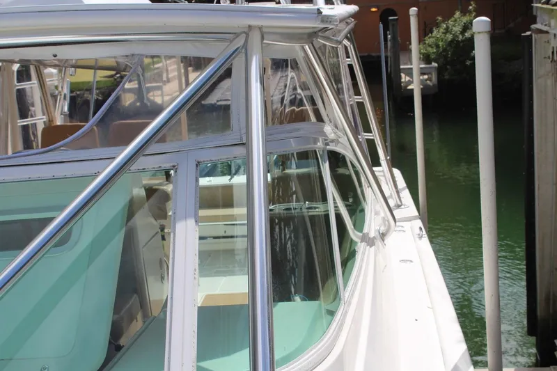 Slide: The Image of 2008 Contender 38 Express boat docked, showcasing sleek design and polished metalwork. - 8