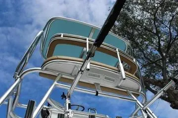 Slide: The Image of 2008 Contender 38 Express boat tower against blue sky and tree backdrop. - 9