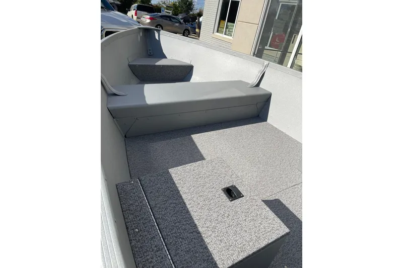 Slide: The Image of 2026 Alumacraft V14 boat interior with gray seating and carpeted flooring. - 3