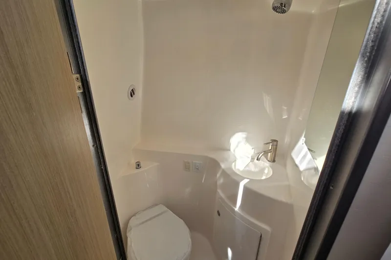 Slide: The Image of Compact bathroom in 2026 Regal 26 XO boat with toilet and sink. - 10