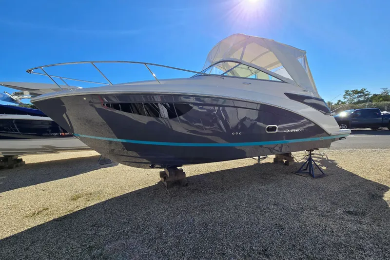 Slide: The Image of 2026 Regal 26 XO boat on display under clear blue sky. - 2