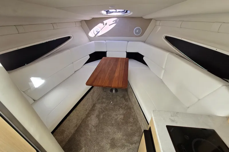 Slide: The Image of Luxurious interior of 2026 Regal 26 XO boat with white seating and wooden table. - 7