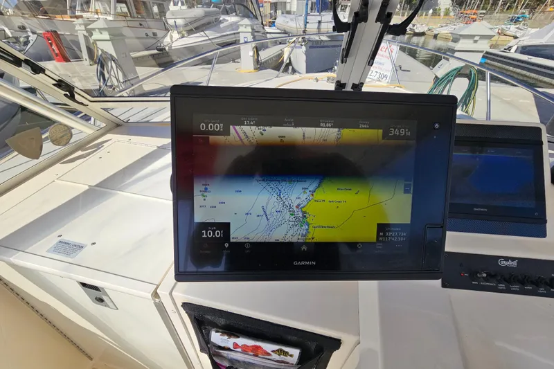 Slide: The Image of 2006 Carolina Classic 25 Express boat with Garmin navigation display at the helm. - 11