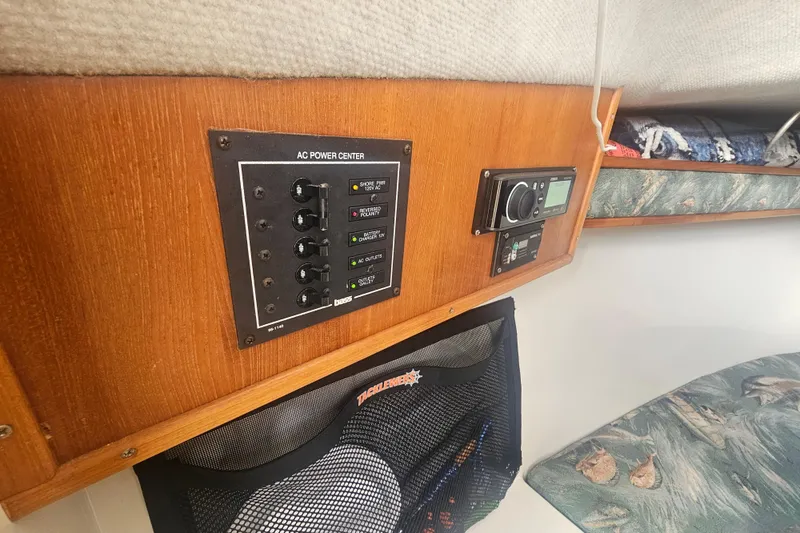 Slide: The Image of 2006 Carolina Classic 25 Express cabin with AC power center and control panel. - 21