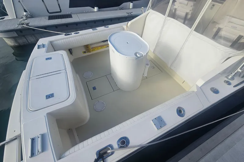 Slide: The Image of 2006 Carolina Classic 25 Express boat interior with seating and storage compartments. - 22