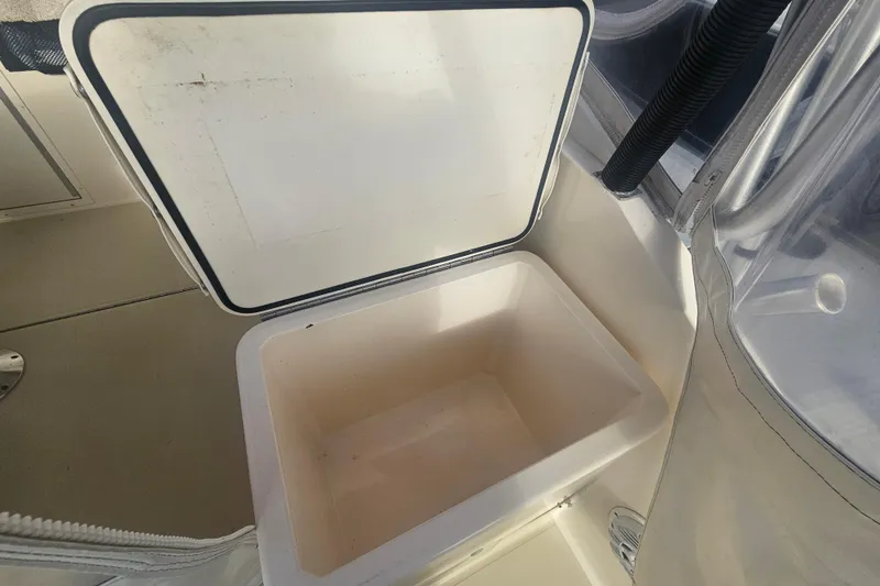 Slide: The Image of Open storage compartment on a 2006 Carolina Classic 25 Express boat. - 24