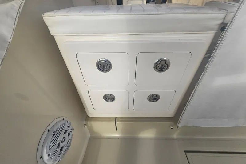 Slide: The Image of 2006 Carolina Classic 25 Express boat interior with storage compartments and speaker. - 27