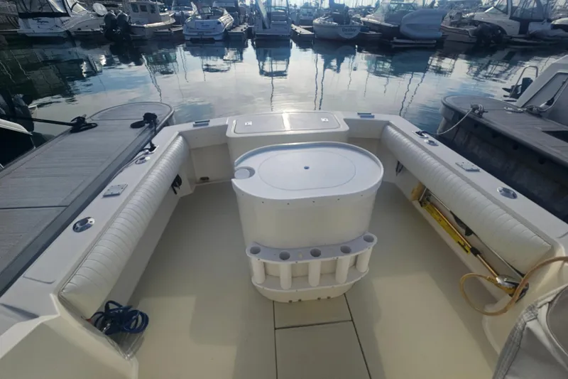 Slide: The Image of 2006 Carolina Classic 25 Express boat interior at marina, featuring spacious seating and storage. - 3