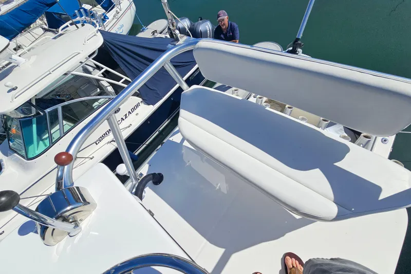 Slide: The Image of 2006 Carolina Classic 25 Express boat with white seating and control panel, docked at marina. - 6