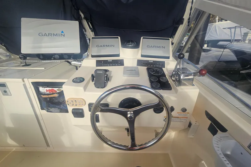 Slide: The Image of 2006 Carolina Classic 25 Express helm with Garmin navigation system and controls. - 8