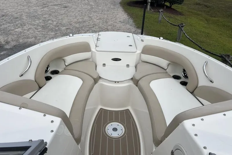 Slide: The Image of 2015 Stingray 234LR boat interior with beige seating and cup holders. - 10
