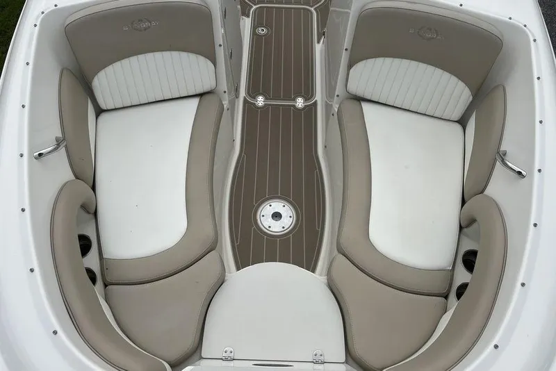 Slide: The Image of 2015 Stingray 234LR boat interior with beige and white seating, wood-style flooring. - 12