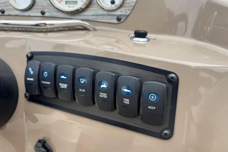 Slide: The Image of Control panel of a 2015 Stingray 234LR boat with various switches. - 16