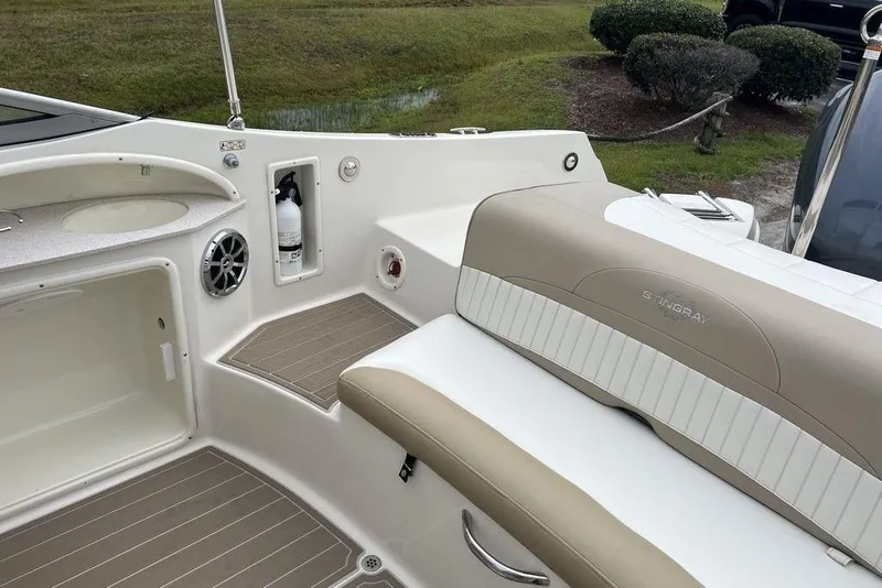 Slide: The Image of 2015 Stingray 234LR boat interior with seating, speaker, and fire extinguisher. - 17