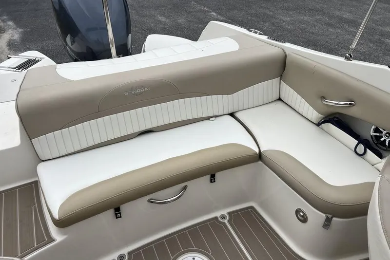 Slide: The Image of 2015 Stingray 234LR boat interior with beige and white seating. - 20