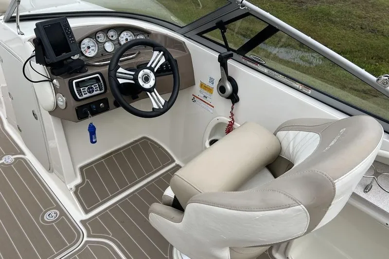 Slide: The Image of 2015 Stingray 234LR boat interior with steering wheel and control panel. - 22
