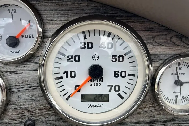 Slide: The Image of Dashboard gauges of a 2015 Stingray 234LR boat, showing RPM, fuel, and hours. - 24