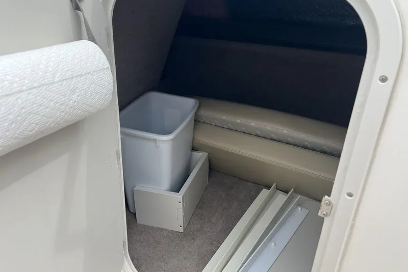 Slide: The Image of Interior cabin of 2015 Stingray 234LR boat with storage and seating area. - 26